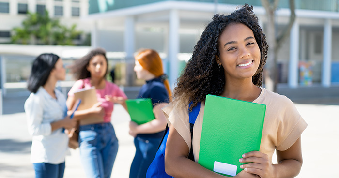 Laughing african american female student with group of young adults